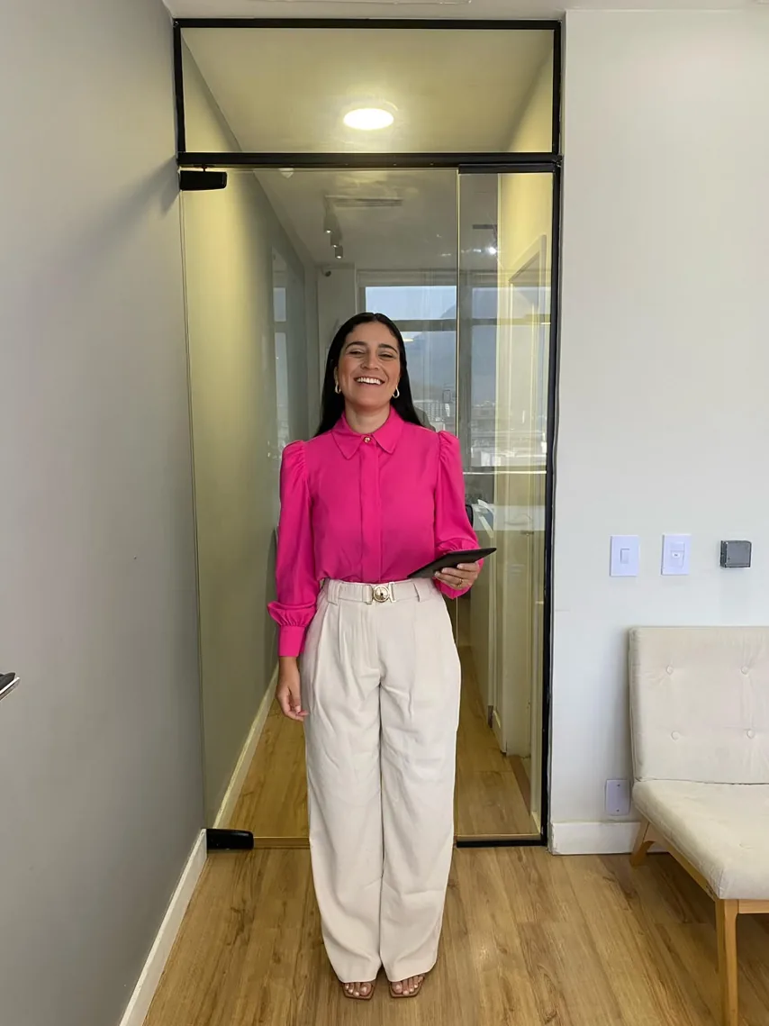 Rebeca Braga sorrindo na entrada do consultório